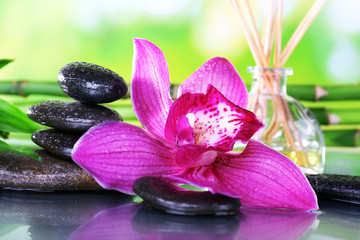 Obraz na płótnie Canvas Spa stones, sticks, bamboo branches and lilac orchid