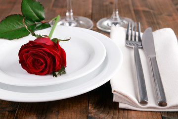 Fototapeta na wymiar Table setting with red rose on plate