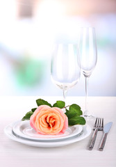 Table setting with pink rose on plate