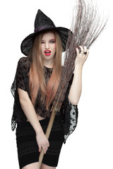 Woman winking eye in witch costume with a broom