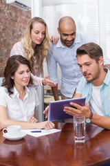 Businesswoman pointing tablet pc in meeting