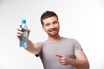 man in jeans and a T-shirt with bottle of water