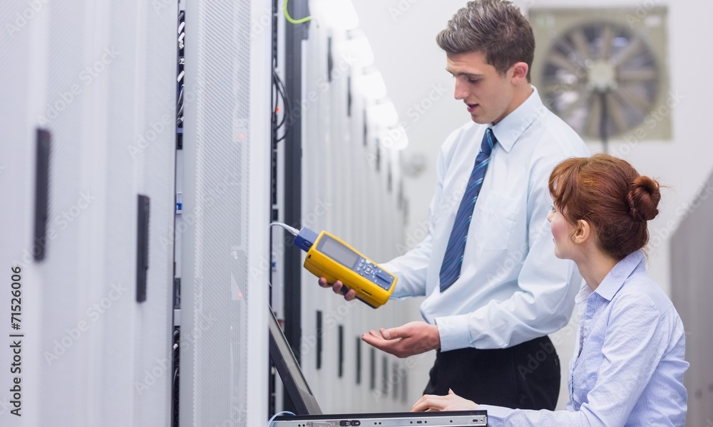 Aufkleber team of technicians using digital cable analyser on servers