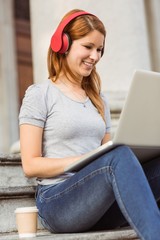 Happy enjoying woman listening with headphones to music