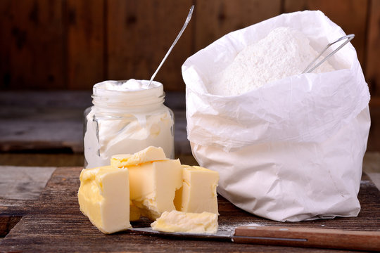 Bag of whole flour on wooden background