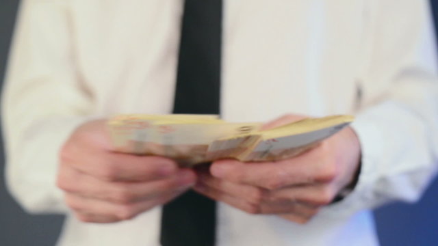 Businessman counting 50 euro banknotes money