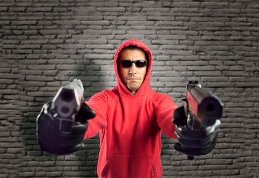 Robber Pointing Two Guns