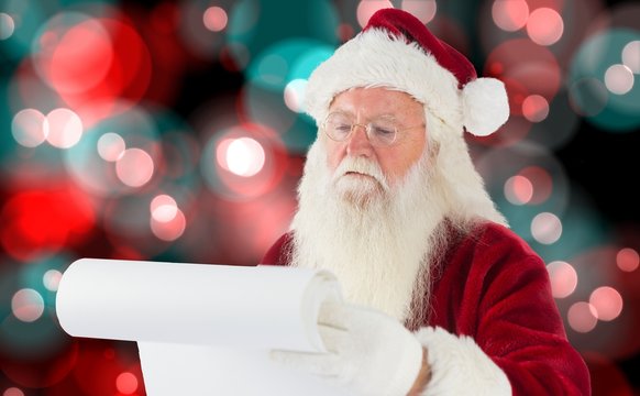 Composite image of santa claus checking his list