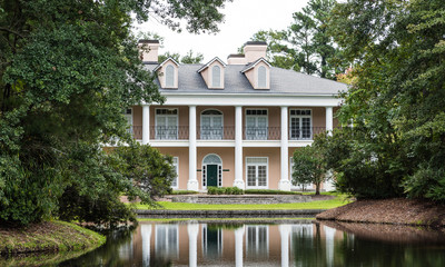 Plaster Mansion with Columns and Reflection in Lake