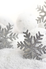 Christmas snowflakes on white snowy background