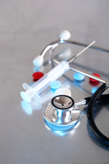 Stethoscope, syringe, pills