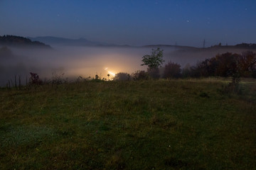 cold fog before sunrise in mountains