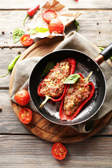 Delicious stuffed peppers in frying pan on table close-up
