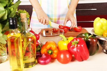 Woman cooking vegetable salad in kitchen