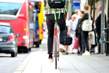 Fototapeta premium Person on bike in traffic