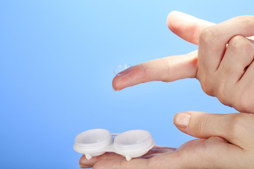 Woman holding container with contact lenses, close-up