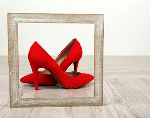 Red women shoes with frame on floor