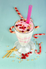 Cranberry milk dessert in glass  on color wooden background