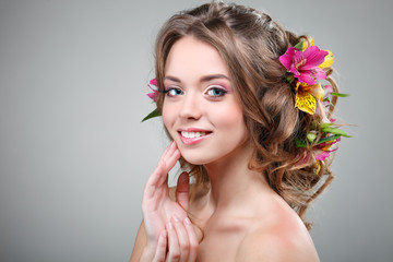 Beautiful  girl  with varicoloured flowers in hairs