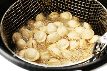 Dumplings in deep fryer, closeup