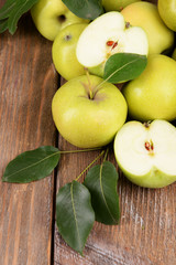 Ripe green apples on wooden background
