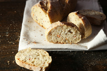 Sliced white bread on white napkin on wooden background
