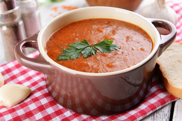 Delicious lentil cream-soup on table close-up