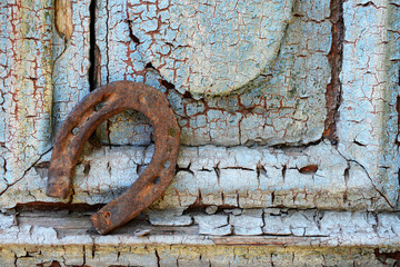 Old horse shoe on vintage wooden door, outdoors