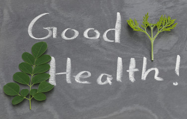 Moringa leaves with Good Health written in a slate
