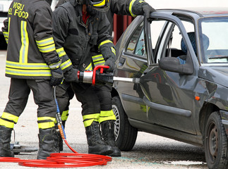 Firefighters open the door with a powerful pneumatic shears