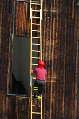 fireman during a demonstration of using the ladder to reach the