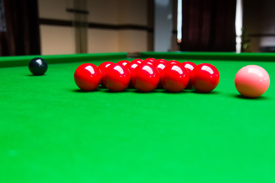 Snooker balls on green pool table