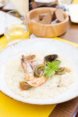 Seafood risotto with shrimp, tomatoes and basil