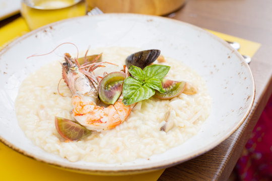 Seafood risotto with shrimp, tomatoes and basil