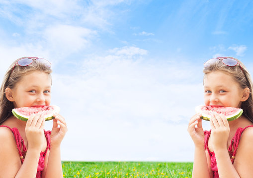 Two Girls Twins Eating Watermelon On Blue Sky Background