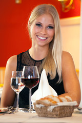 Beautiful woman sitting at a table in a restaurant.