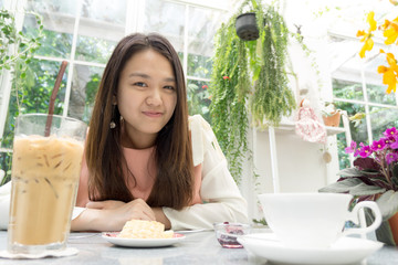 Asian young lady on the dining table with decorative flower