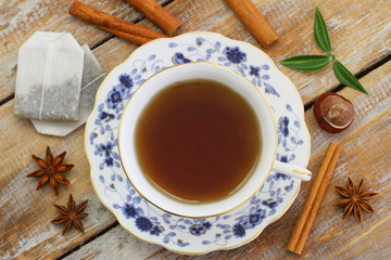 Cup of tea, star anise, cinnamon, autumn leaves and chestnuts