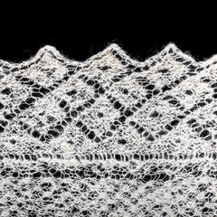 edge of texture wool knitted cloth handmade on a black backgroun