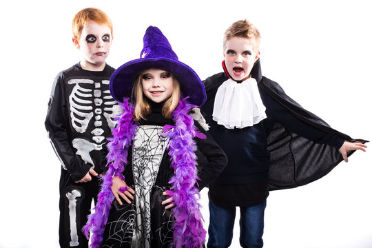 Three cute child dressed the Halloween costumes