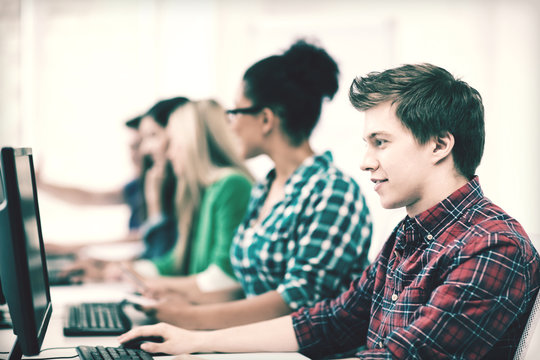 student with computer studying at school