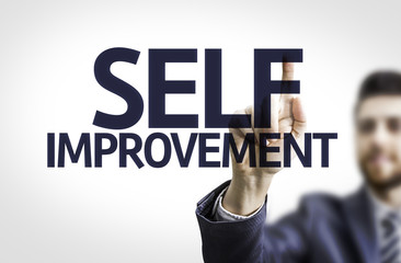 Business man pointing the text: Self Improvement