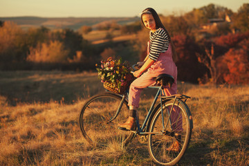 Oldfashioned girl ready to ride a retro bike