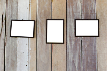 three blank frame on wood wall