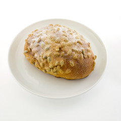 fresh bread with soybean and icezing topping on white plate isol