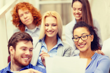 Fototapeta premium team with papers and take away coffee on staircase