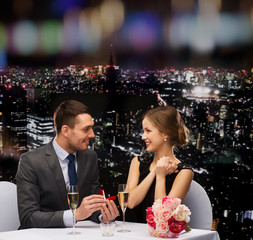 man proposing to his girlfriend at restaurant