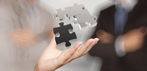 businessman hand showing 3d puzzle partnership sign as concept