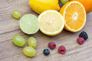 Fototapeta na wymiar Grapes, Lemons, Oranges And Berries