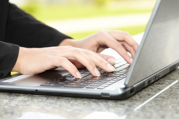 female hand writing on laptot